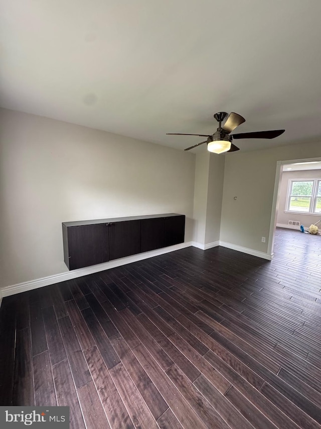 1333 E Northern Pkwy, Baltimore, MD 21239 - empty room featuring dark wood finished floors, ceiling fan, and baseboards