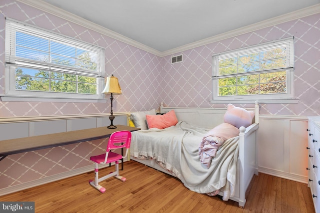 3219 Sunset Ave, Norristown, PA 19403 - bedroom featuring wallpapered walls, ornamental molding, light wood-style flooring, multiple windows, and a decorative wall