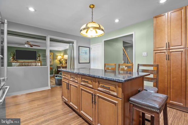 3219 Sunset Ave, Norristown, PA 19403 - kitchen with recessed lighting, dark stone countertops, ceiling fan, a kitchen island, and hanging light fixtures