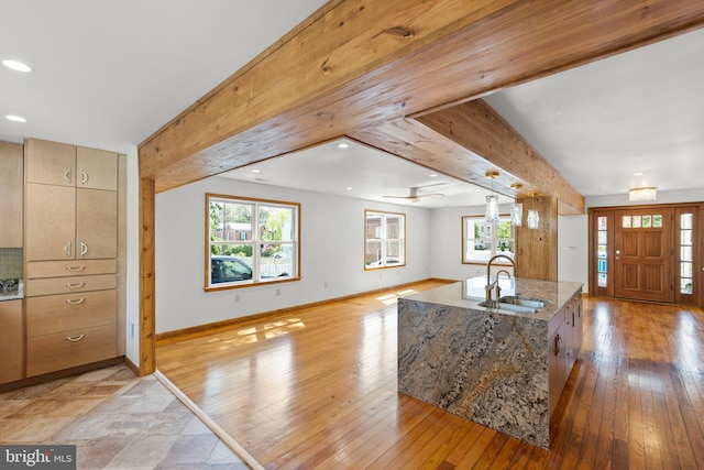 foyer featuring baseboards, recessed lighting, light wood-style flooring, and beam ceiling