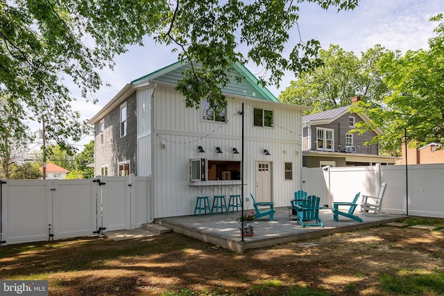 back of house with a patio, a gate, and a fenced backyard