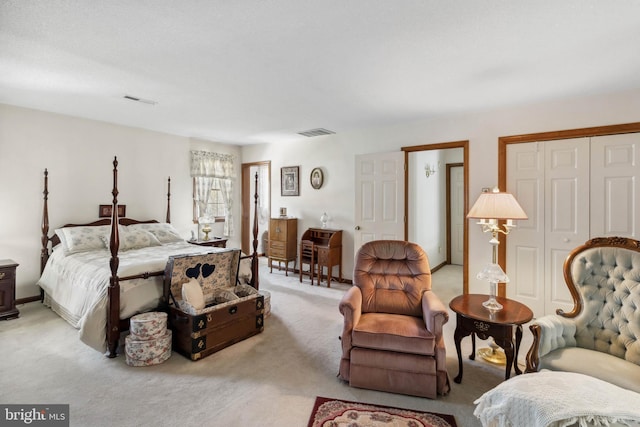 bedroom featuring a closet and light carpet