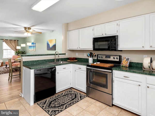 kitchen featuring a sink, dark countertops, white cabinets, and black appliances