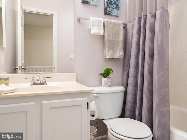 bathroom with vanity, shower / bath combination with curtain, and toilet