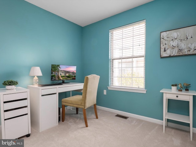 office with baseboards, light colored carpet, plenty of natural light, and visible vents