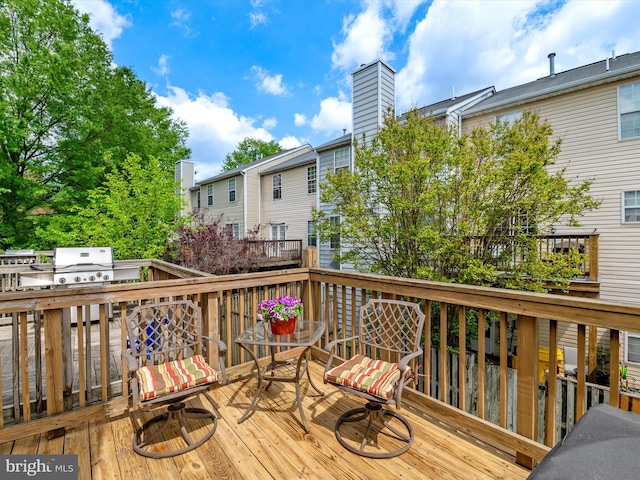 wooden deck with a grill