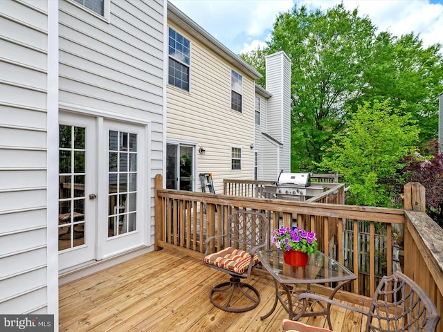deck with french doors and a grill