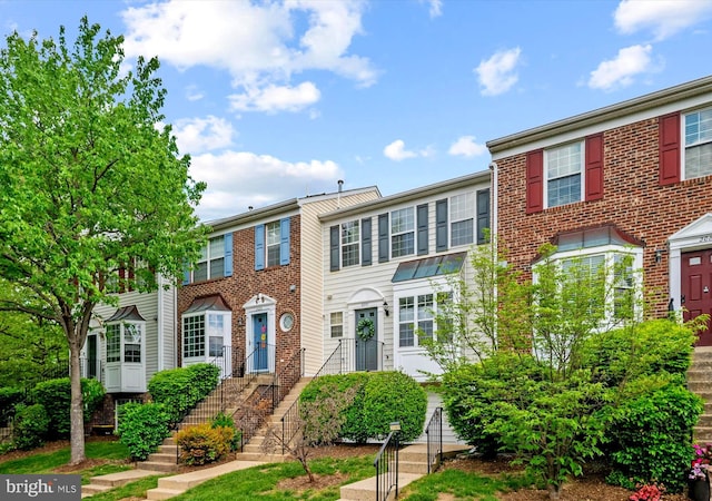 townhome / multi-family property featuring brick siding