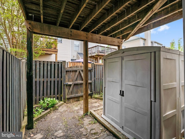view of shed featuring a fenced backyard and a gate