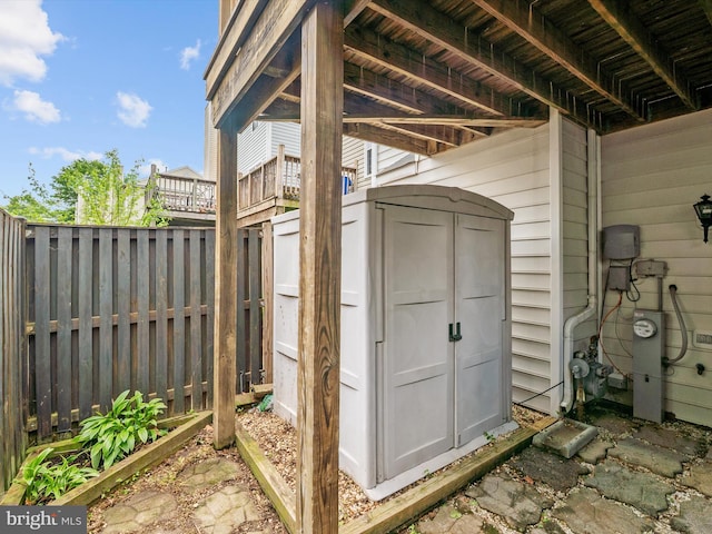 view of shed featuring fence