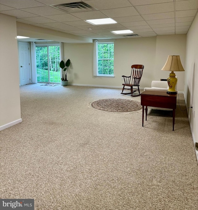 sitting room featuring carpet floors, baseboards, visible vents, and a drop ceiling