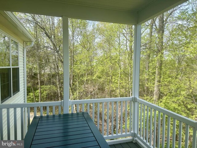 exterior space featuring a view of trees and outdoor dining area