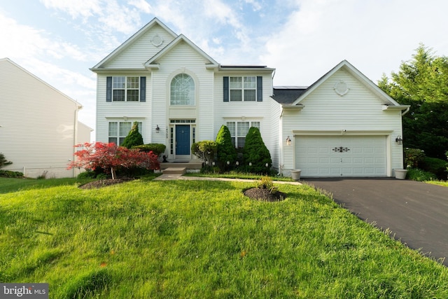 view of front facade with asphalt driveway, a front lawn, and a garage