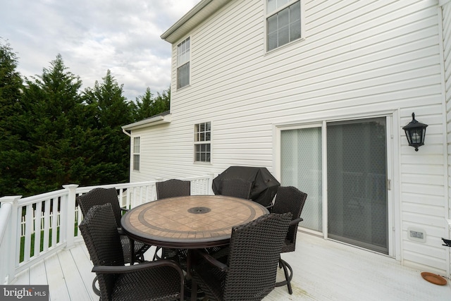 wooden terrace with outdoor dining area