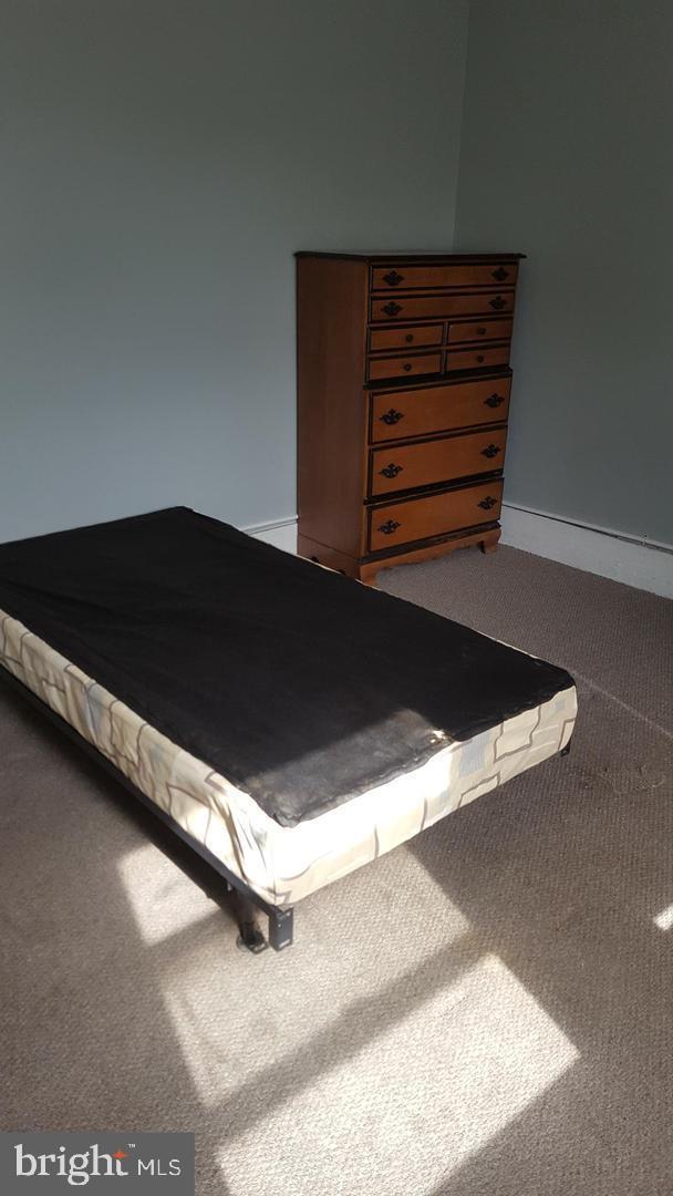 bedroom featuring carpet floors and baseboards