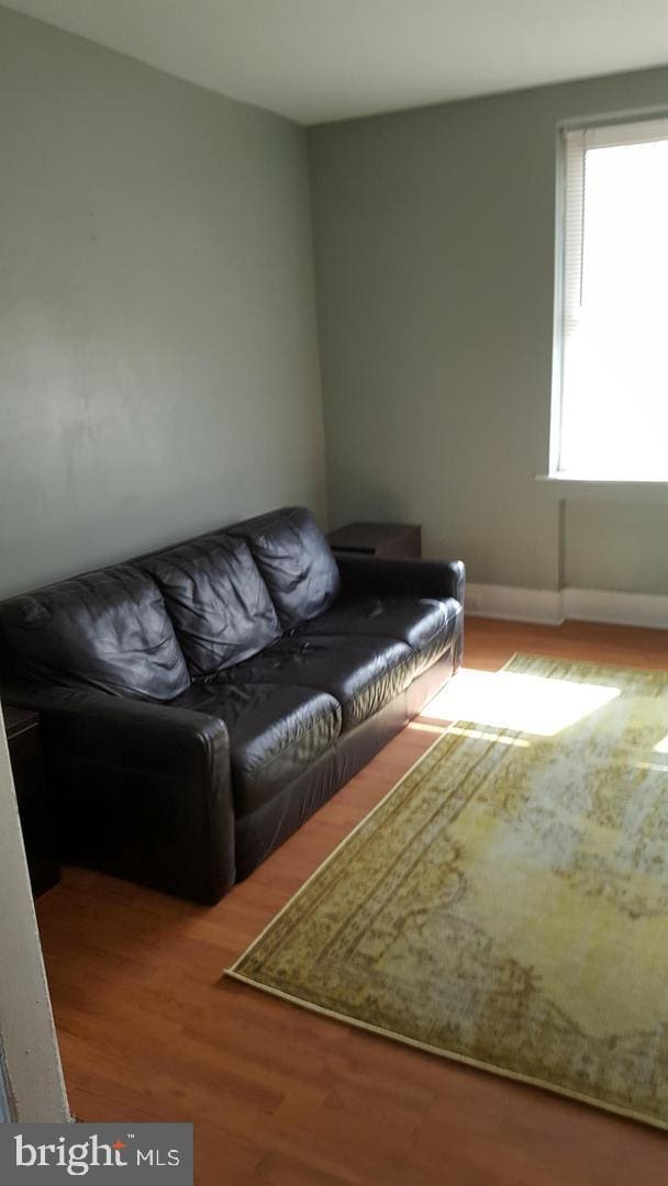 living room with baseboards and wood finished floors
