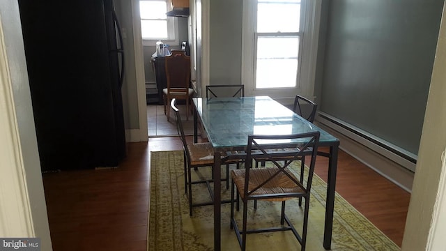 dining room with wood finished floors and a baseboard radiator