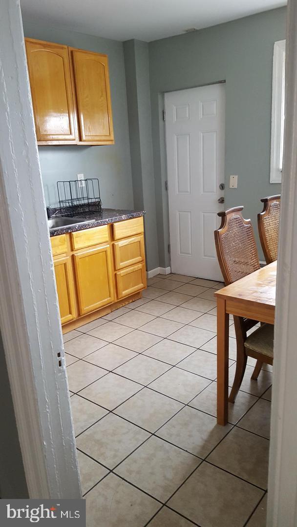 kitchen with baseboards and light tile patterned flooring