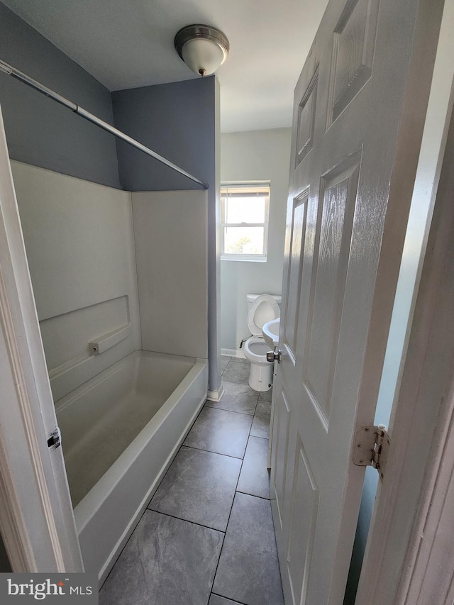 full bath featuring tile patterned flooring,  shower combination, baseboards, and toilet