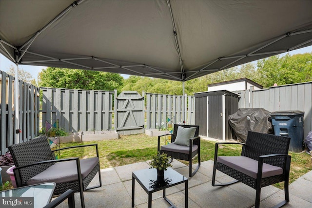 1653 Forest Park, District Heights, MD 20747 - view of patio / terrace with grilling area, a shed, a fenced backyard, a gate, and an outbuilding