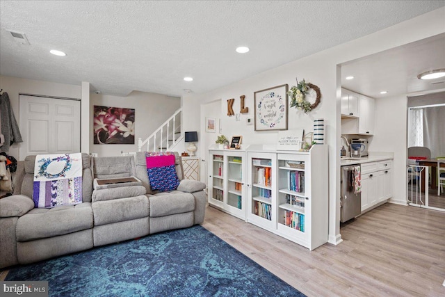1653 Forest Park, District Heights, MD 20747 - living area with light wood-style floors, stairway, recessed lighting, and a textured ceiling