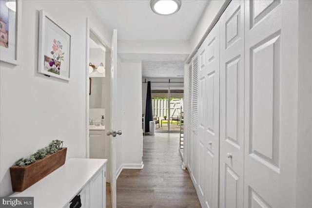 1653 Forest Park, District Heights, MD 20747 - corridor with a sink, baseboards, and dark wood-style flooring