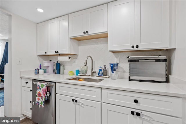 1653 Forest Park, District Heights, MD 20747 - kitchen featuring a sink, light countertops, white cabinetry, backsplash, and stainless steel dishwasher