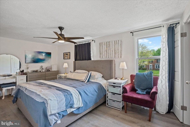 1653 Forest Park, District Heights, MD 20747 - bedroom featuring a textured ceiling, ceiling fan, and wood finished floors