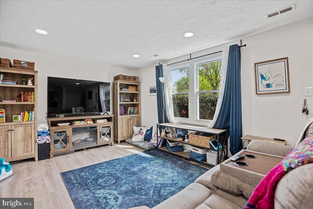 1653 Forest Park, District Heights, MD 20747 - living area featuring visible vents, recessed lighting, a textured ceiling, and wood finished floors