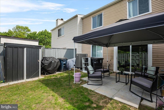 1653 Forest Park, District Heights, MD 20747 - back of house featuring a lawn, a patio area, central AC, and fence