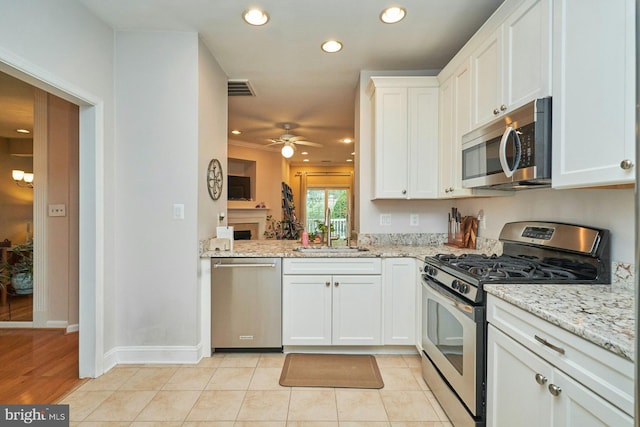 kitchen featuring ceiling fan, visible vents, a sink, white cabinetry, and appliances with stainless steel finishes
