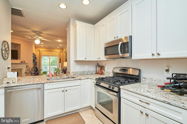 kitchen with white cabinets, appliances with stainless steel finishes, visible vents, and a sink