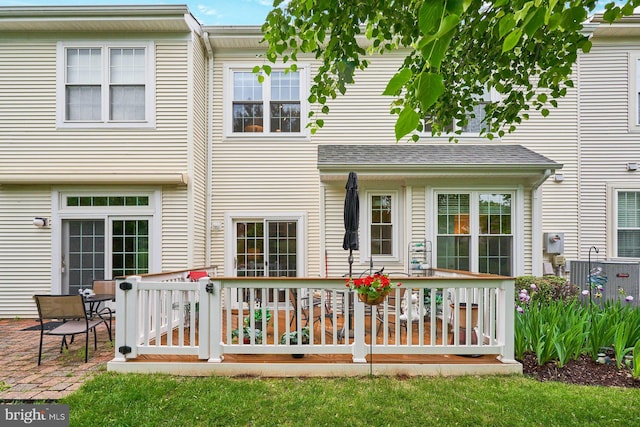 back of property with a wooden deck