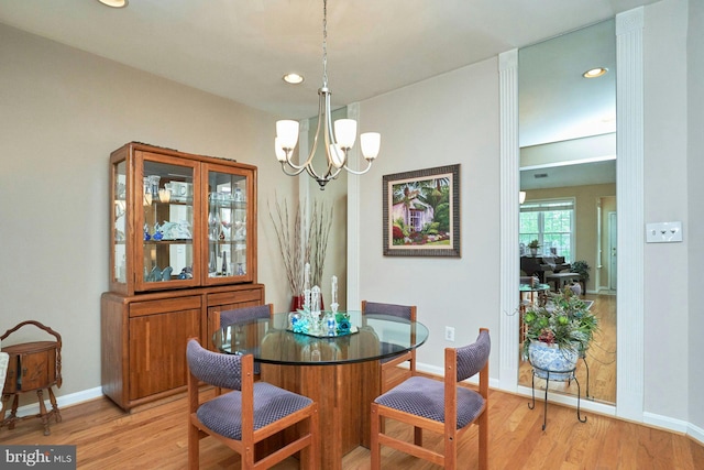 dining room with light wood-style floors, a chandelier, baseboards, and recessed lighting