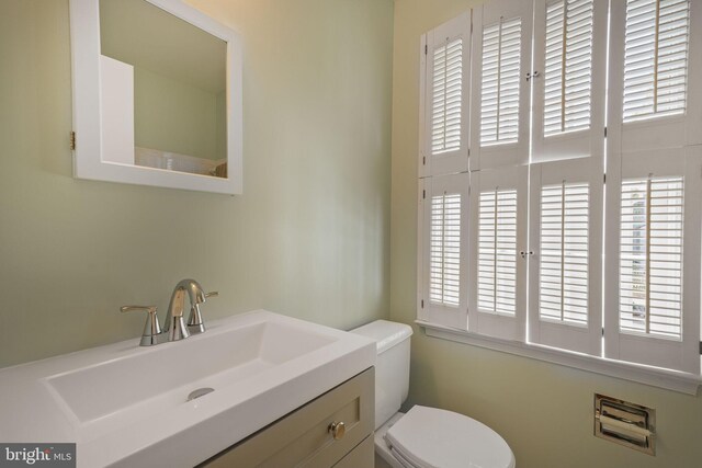 half bath with vanity and toilet