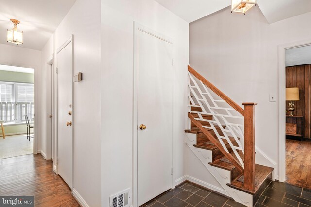 interior space with baseboards, stairs, and visible vents