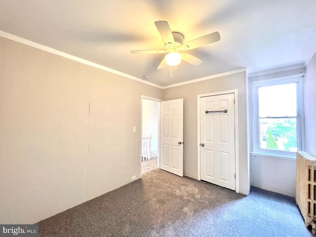 unfurnished bedroom with carpet floors, ornamental molding, and ceiling fan