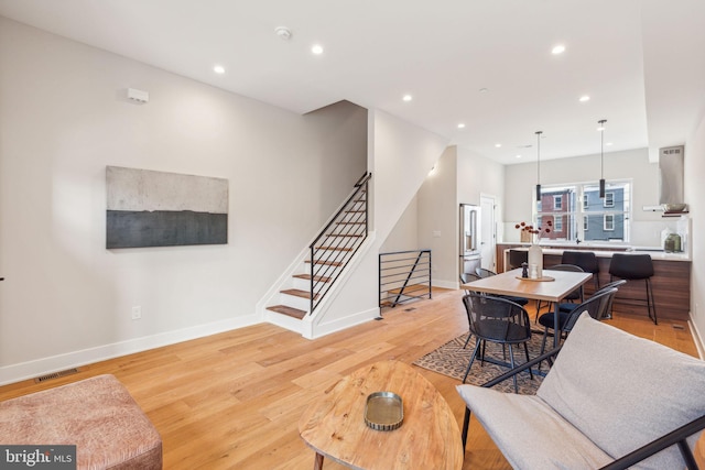 dining area with recessed lighting, visible vents, stairway, and light wood-style floors