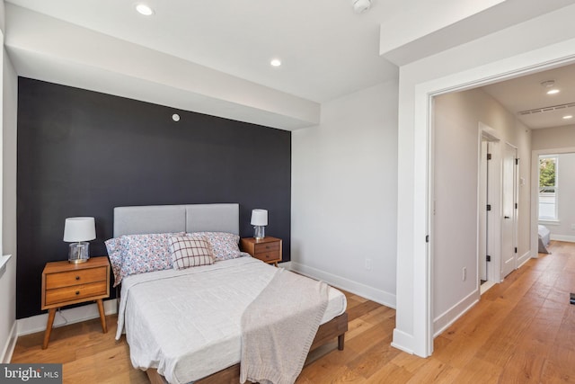 bedroom featuring recessed lighting, baseboards, and light wood-style floors
