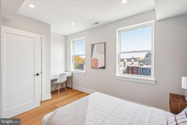 bedroom with recessed lighting, baseboards, visible vents, and wood finished floors