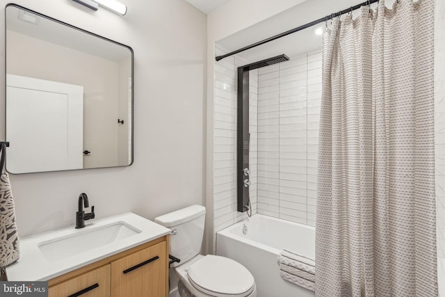 full bath with vanity, shower / bath combo with shower curtain, and toilet