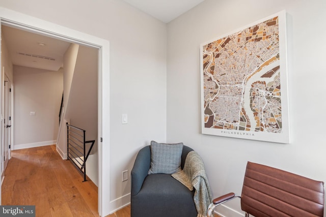 living area featuring baseboards and light wood-style floors