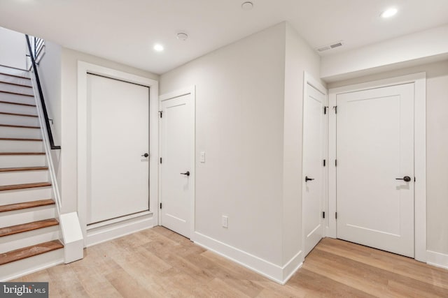 foyer featuring stairs, recessed lighting, and light wood-style flooring