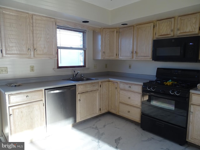 kitchen with a sink, black appliances, and light brown cabinets