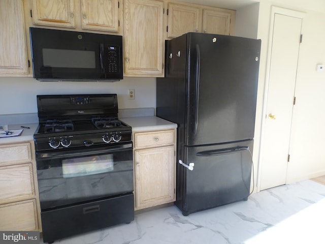 kitchen with light countertops, light brown cabinetry, black appliances, and marble finish floor