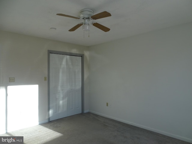 spare room with carpet floors, baseboards, and ceiling fan