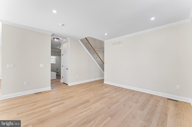 unfurnished living room with visible vents, light wood-style flooring, crown molding, and baseboards