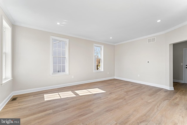 spare room with visible vents, light wood-type flooring, baseboards, ornamental molding, and recessed lighting