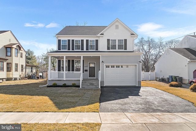 view of front of home with a porch, driveway, roof with shingles, a front lawn, and an attached garage