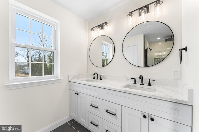 bathroom featuring a sink, baseboards, tile patterned flooring, and double vanity